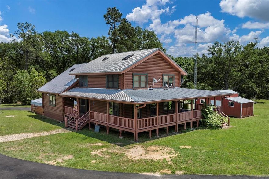 A true East Texas escape where land, water, wildlife, and craftsmanship come together in a way that’s nearly impossible to find. From the moment you pull in on the asphalt driveway, you feel it—privacy, peace, and something special. The 2,500 sq ft log cabin sits perfectly positioned, overlooking a breathtaking 7-acre private lake. Not just for looks, but proven—producing bass up to 10 pounds. Whether it’s morning coffee on the wraparound porch or evenings watching the sun drop over the water, this is the kind of place people dream about but rarely find. Sitting on 44+ acres, this property is set up for real living. The home offers a warm, flowing floor plan with a spacious kitchen featuring granite countertops, island, and abundant storage. A large primary suite, dedicated office, and thoughtful log cabin craftsmanship throughout make it both functional and full of character. Step outside and you’ll find everything you need—shop with electricity, storage building, covered parking for equipment and toys, plus a small irrigated blueberry field adding charm and potential. Location seals the deal. Minutes from I20. 1 hour to Dallas, under an hour to Tyler, and minutes from Canton and the world-famous First Monday Trade Days—giving you convenience without sacrificing privacy. If you’ve been waiting for something truly different… this is it. Land. Water. Wildlife. Privacy. Character. A property you simply can’t recreate.