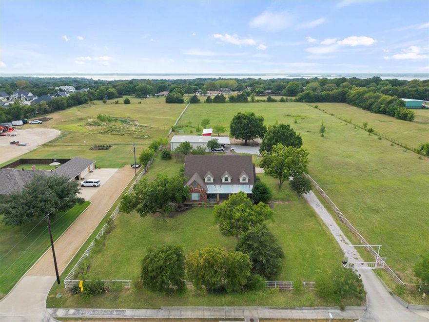 Property includes 2 separate lots, one with 2.721 acres the 2nd with 2.719 acres for a total of 5.44 acres. Step into this beautifully updated classic Texas haven in the heart of Heath, TX. This spacious residence boasts 4 bedrooms, 4 bathrooms, office, 2 car garage, 2000 sf shop with electricity and water and a new 2 stall barn. It is ideal for those seeking a serene retreat with plenty of room for their family and horses to spread out as the property is fully pipe fenced and gated. Outdoors you will enjoy the multiple mature fruit and pecan trees. There are so many updates that make this home shine. Some of the updates include 2 new HVAC systems, 2 new hot water heaters, freshly painted inside and out, new countertops, sinks, fixtures and hardware, in addition to painted cabinets in the kitchen and bathrooms, all new ceiling fans and LED light fixtures. This home features a cathedral ceiling in the large family room with a gorgeous 2 story TX stone fireplace that you will love! This Heath residence offers everything you need and more Come and discover your perfect retreat today.