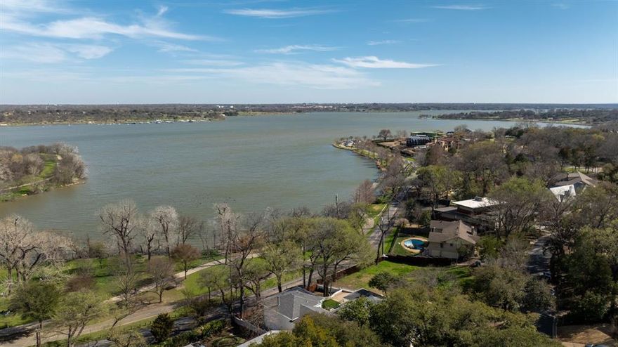 Stunning home in The Cloisters, one of East Dallas’ most coveted neighborhoods, w panoramic views of White Rock Lake. Redesigned by award winning firm Maestri Studio, this show home features 5591 SF with chic touches thru-out from gorgeous lighting + tile to elegant stone selections. Main floor anchored by large LR that opens to oversized patio for a seamless flow indoors to out. Chef's kitchen features Imperiale stone waterfall island, Macaubus Quartzite countertops, Ann Sacks tile + double Sub-Zero Wolf refrigerators. 4 bedrooms, incl the owner’s suite, located on the 1st floor w generous dimensions, large windows + en-suite BAs. Primary suite is situated to enjoy sunrise views over the lake + boasts a gorgeous BA w opal white satin marble, gorgeous lighting + beautiful tile around oversized shower + soaking bath. 2nd level feat 20x28 flex room that can serve as 5th BR, office or add'l living area w fireplace, wraparound windows, large balcony + private BA. Idyllic indoors and out.