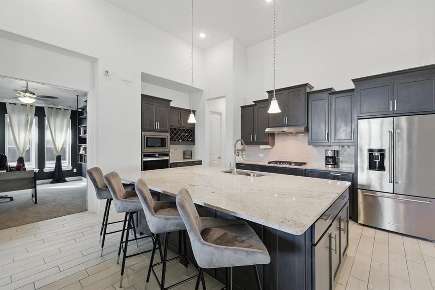 PRICE IMPROVEMENT, REDUCED $10,000, PRICED WELL BELOW MARKET!! Spacious SINGLE STORY Featuring 14 Foot Ceilings, High-End Details, Architectural Bonuses & Custom Designer Touches Throughout in ARGYLE ISD! Dramatic Entry*Extensive Hardwood Floors*Soft Neutrals & Striking Decorator Accents*Dedicated Office would also make a great 2nd Living or Exercise Room*You will love the Expansive Kitchen with the LARGEST ISLAND you've ever seen & how it flows into the Living Area & Formal Dining, making the whole space one seamless comfortable room*Abundant Cabinets & Countertop Workspace, Decorator Backsplash, Quartz, Stainless Appliances, Gas Cooktop & a HUGE WALK-IN PANTRY! What more could any chef want? Formal Dining offers easy access to the Kitchen for those large gatherings*Floor to Ceiling TILE FIREPLACE accents the Living Area, along with a Wall of Windows to Maximize Natural Light*FOUR SPLIT BEDROOMS w FOUR ACCESSIBLE BATHS are located in separate corners of the home allowing privacy*Large Ensuite Primary Retreat features Artistic Touches, a Wall of Windows & a Private Bath to die for: Dual Vanities, a Sitting Vanity, Soaking Tub, Frameless Glass Shower & Two Walk-In Closets*Movies & Popcorn Anyone? You'll have a fantastic MEDIA ROOM w SURROUND SOUND complete & ready to go*Large Utility Room and a Mud Room are just off the 3 car garage*Do you like to entertain? You are going to enjoy the Covered Patio, Outdoor Fireplace and Sizeable Backyard - there is even a gas jet for your grill just in case you want to create and outdoor kitchen! Add all of this together & you get a Practical Single Story Home with the Grand Luxurious Feel of Elegance, Privacy & Easy Living for MULTI-GENERATIONAL Living or a Single Person**Harvest offers so many amenities! Club House, Coffee House, Ball Courts Pools, Playgrounds, Fishing, Dog Parks, Fitness, Jogging & Bike Paths, Lake, Greenbelts, Full Time Professionally Planned Activities, Back to Nature Crop Sharing & More*