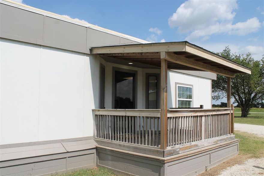 Bonus! Sign a 12 month lease and get the 7th month rent FREE!   
Step onto the covered front deck and come into this unique small house just made for you! Kitchen has beautiful counters, lots of storage & a nice breakfast bar top. Lots of windows make it sunny & bright. All new laminate flooring throughout and fresh paint inside! Two bedrooms in the hallway, and a large room at the rear that has so many possibilities! It could be used as a bedroom, office, sewing or crafts room...The manufactured home is located in a small, quiet, well maintained mobile home park. Rent includes trash pickup, water and lawn maintenance. Just outside of Krum, kids go to Krum ISD. About 5 miles to I35, so it's easy to get to shopping and dining. * Tenant + Tenant's agent is responsible for verifying all information, measurements, schools, fees and regulations.