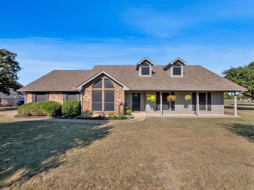 Welcome to this beautifully updated 4-bedroom, 2-bath home on a desirable corner acre lot. Inside, you'll find fresh paint throughout and updated laminate flooring. The bright kitchen features updated appliances and opens to a cozy dining area — perfect for family meals and entertaining. At the heart of the living space is a stunning wood-burning fireplace, creating a warm and inviting focal point for gatherings or quiet nights in.  The spacious primary bedroom offers a relaxing retreat with updated carpet, two walk in closets, and complete with an ensuite bathroom featuring a garden tub. Split floor plan places three additional guest bedrooms and a full guest bathroom on the opposite side of the home providing  privacy for family or visitors. Enjoy peaceful mornings on the welcoming front porch and relaxing evenings on the covered back porch, overlooking a large, private backyard with plenty of room to roam, garden, or play. Don’t miss the chance to call this property your new home!!