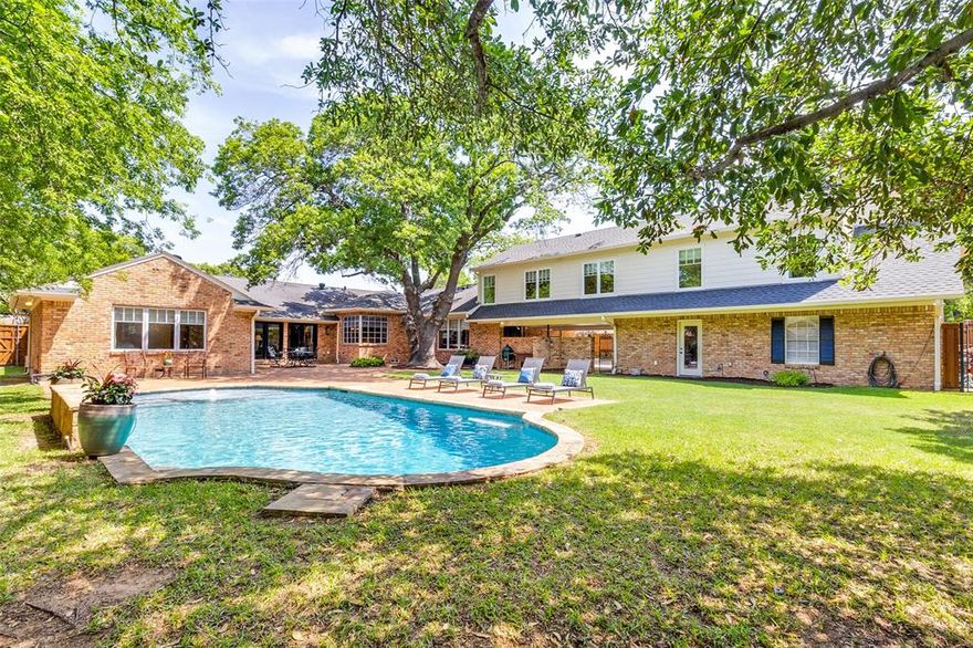 Welcome to your dream home on coveted Crooked Lane—where charm, space, and thoughtful updates come together seamlessly. Set on over half an acre, this professionally remodeled and expanded ranch offers the perfect blend of comfort and functionality for everyday living and entertaining.
Inside, you’ll find 5 spacious bedrooms, 5 full baths, and 2 half baths—including a convenient pool bath—plus multiple living and dining areas designed with flexibility in mind. The chef’s kitchen features marble slab countertops, a large corner window with backyard views, and opens to the family room with soaring beamed ceilings and a cozy fireplace. A formal dining room, breakfast nook, and large upstairs game-media room offer room to gather and grow. Step outside to your private backyard retreat, complete with a beautiful pool, pool bath, expansive patio, and a gated driveway with space for pickleball, ping pong, or cornhole. The climate-controlled workshop provides even more room for hobbies or storage- 6.5x20ft. Meticulously maintained and move-in ready, this home includes updates to electric, gas, plumbing, flooring, cabinetry, and fixtures throughout. Located in the heart of the Private School Corridor and zoned to highly-rated Withers Elementary, it’s the ideal setting to put down roots and make lasting memories.