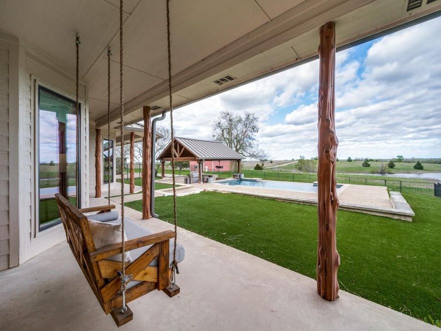 Breathtaking 13+ acre property just a 10 min from shopping, restaurants, golfing and schools.  Relax and watch the sun rise over shared lake and private pond. Property is Ag Exempt. 3 of 5 bedrooms are downstairs all with ensuite bathrooms. Front bedroom is perfect for an office. Walk into  Open Living Area and enjoy 180 degree views of the countryside and gorgeous pool w outdoor entertainment area.  Turfed and fenced back yard with separate fenced dog run. Swim up to the bar of the sunken entertainment area refrigerator and built in grill. Pool has designated lap swim area. Huge game room upstairs with the same stunning views out the wall to wall windows.  Home has been updated w Hand scraped wood, new windows, modern kitchen, bathrooms. Generator is wired to the home for unplanned power outages and the metal roof should last a lifetime. The barn is insulated and set up as a workout TV area. It is large enough for indoor batting cage and more. This home is Luxurious Country Living.