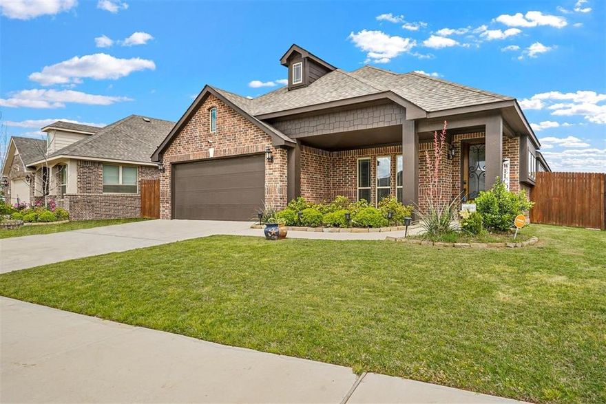 A 3-bedroom, 2-bath, 2-car garage home with an open floor plan is perfect for entertaining and living, and featuring simulated wood grain ceramic tile flooring throughout main traffic areas. The kitchen opens up to the family room with a spacious island. The stunning bay window will brighten your day with natural sunlight. Family room boasts an inset theatre-style area with accent lighting, perfect for movie nights. The primary bedroom has an elongated window seat, a large walk-in closet, dual sinks, a garden tub, and a step-down shower. You will not lack room for organizing with full attic decking or creating additional living space. This property has an essential covered front porch and covered back patio.