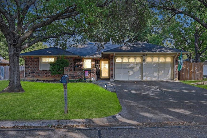 Welcome home to this beautifully updated 3-bedroom, 2-bath property that perfectly blends modern style with timeless character. Every detail has been thoughtfully refreshed while maintaining the warmth and charm you’ve been searching for. Step inside to discover an open, inviting layout filled with natural light. The spacious living room is perfect for entertaining or relaxing, featuring luxury vinyl plank floors, a cozy gas log fireplace, and sliding glass doors that open to the large covered patio—ideal for outdoor dining, gatherings, or quiet evenings at home. The kitchen is a true delight with plenty of cabinets for storage, stainless steel appliances, and generous counter space for meal prep and entertaining. A bright and cheerful breakfast nook easily fits a table for six and showcases a charming bay window, making it the perfect spot for morning coffee or family meals. The primary suite is spacious and serene, offering a beautifully updated ensuite bath with a large tiled walk-in shower, stylish fixtures, and his and her walk-in closets for exceptional storage. The two additional bedrooms are comfortable and versatile, ideal for family or guests. Home also features a home office, perfect for a quiet place for kids to study or remote workers. Nestled in a fantastic location near Pantego and Dalworthington Gardens, this home offers the best of both worlds—peaceful suburban living with easy access to everything you need. You’re just minutes from shopping, dining, parks, schools, and major roadways for easy commuting. Immaculately maintained and move-in ready, this home combines modern updates, timeless charm, and a wonderful location. Don’t miss your chance to make it yours—schedule a private tour today and fall in love with all the thoughtful details this home has to offer!