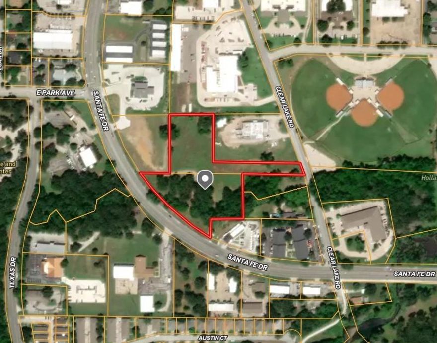 Well located Tract of land on Santa Fe Drive. Great visibility.  Adjoins a new bank to the North. There are new construction starts close by that should break ground in 2026. The front of the property is zone C-1 and could be several smaller pad sites.  The back acreage is zoned Industrial and could be a small upscale industrial park.  OWNER FINANCING IS AVAILABLE.