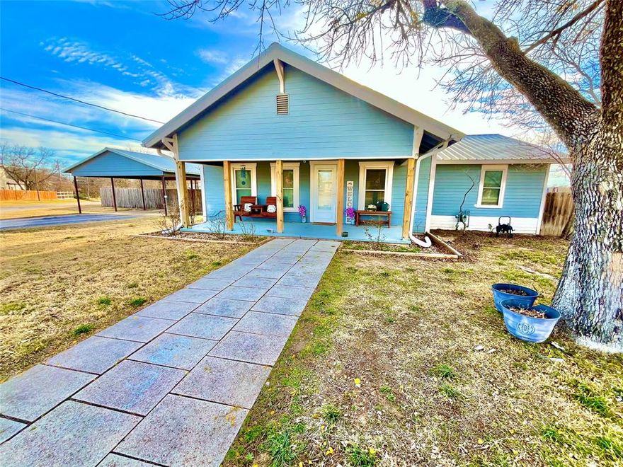 Welcome home to this beautifully renovated 4 bedroom, 2 bath home offering 2,058 SF of comfortable living space on a spacious .51 acre lot.  This move in ready property combines modern updates with small town charm.  Inside, you will find a large open-concept kitchen featuring an oversized island; perfect for gathering, entertaining, and everyday living.  The home offers a great layout with generous living spaces, laminate and carpet flooring throughout, and large walk-in closets providing plenty of storage.  Step outside to enjoy the privacy fenced yard, ideal for kids, pets, or outdoor entertaining.  A 2 car metal carport provides convenient covered parking.  With it's extensive renovations, spacious lot, and prime corner location, this home is ready for its next owner!