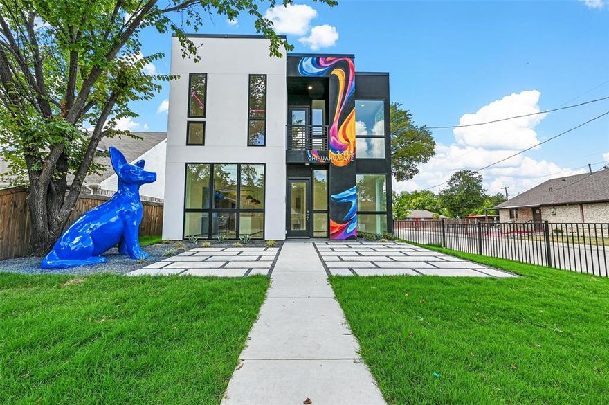 This house comes with a REDUCED RATE as low as 5.875% (APR 6.143%) as of 11.14.2025 through List & Lock™. This is a seller-paid rate buydown that reduces the buyer’s interest rate and monthly payment. Terms apply, see disclosures for more information.

This iconic Chihuahua House in the BOOMING Trinity Groves neighborhood sits proudly on the corner of Kraft St and Chihuahua Ave, where a giant blue Chihuahua statue stands guard over a white picket–fenced, xeriscaped front yard and patio. Designed in an art-minimalist modern style, it features a rear driveway, 10 ft floor-to-ceiling aluminum windows, continuous insulation for improved comfort, and bathrooms washed in natural light through translucent dichroic film. Original Chihuahua-themed accent tile in the kitchen and baths, a 24-ft artist-designed Groves graffiti mural, and a small surprise gift sculpture make this home truly one-of-a-kind and Instagram-ready.