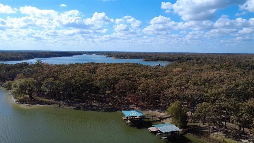 Waterfront Living Awaits you on this prime lot on Lake Tawakoni! Discover the perfect blend of privacy and lake access on this exceptional 1-acre homesite in the sought-after Nautical Shores community. This offering includes an exclusive 1.5-acre lakefront easement, providing you with your own private stretch of waterfront to build a custom dock, cast a line from your personal pier, or simply soak in the tranquil lakeside views. Nestled among mature trees, this beautiful wooded lot offers the ideal canvas  to bring your chosen builder and create your dream home- with plenty of space to design a custom retreat that captures both the serenity of nature and easy access to the water. Nautical Shores community features paved streets, street lights, underground utilities and a gated marina with boat slips at $500 a month. The property includes a Sabine River Authority shoreline leaseback that allows for your own pier up to 150 ft and a boat dock.  Single family builds of 1,400 sqft mim for a 1 story, and 1,800 sqft minimum for a 2 story. Utilities available at the street. With generous dimensions and natural beauty on every side, this property provides the space and privacy you've been searching for, while the lakefront easement ensures you'll enjoy all the benefits of waterfront living!