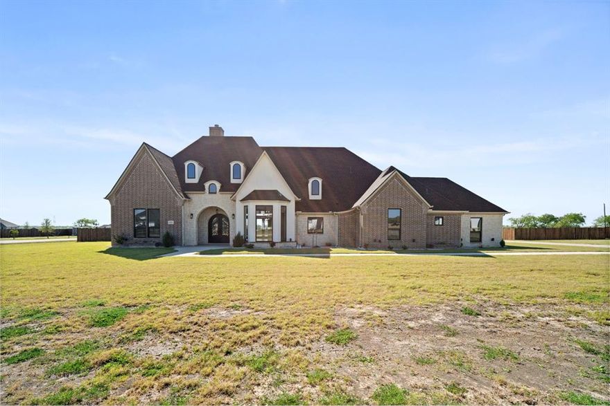 Welcome to GREYSTONE ESTATES WHERE LUXURY MEETS THE LAND. NESTLED WITHIN THE GATES OF ELLIS COUNTY’S MOST COVETED EQUESTRIAN COMMUNITY, this stunning brand new construction home sits on OVER AN ACRE of lush landscape with sweeping views and spectacular SUNSETS that never get old. NO CITY TAXES. NO COMPROMISES. This 4 BEDROOM, 5 FULL BATH MASTERPIECE was designed for those who want it all. The open concept layout flows effortlessly with SOARING CEILINGS, rich built in shelving throughout, and gorgeous QUARTZ countertops that anchor every space. The chef’s kitchen opens to generous living and dining areas, PERFECT FOR ENTERTAINING or simply enjoying the relaxed COUNTRY LIFESTYLE you’ve been craving. The primary suite is a true retreat, featuring a SPACIOUS SITTING ROOM, A DEDICATED SAFE ROOM, and a SPA LIKE PRIMARY BATH with not one but TWO OVERSIZED WALK-IN CLOSETS (HIS AND HERS). The OVERSIZED EPOXIED 3-CAR GARAGE, A GAME ROOM Or Media Room with additional storage...use as you deem fit, a STUDY and thoughtful layout make this home as functional as it is beautiful. HORSE LOVERS, WELCOME HOME!! Greystone Estates delivers RESORT STYLE AMENITIES such as a STATE OF-THE-ART EQUESTRIAN CENTER WITH A ROUND PEN, RIDING TRAILS ALONG a WOODED NATURAL CREEK, AND A CATCH-AND-RELEASE POND WITH PUBLIC DOCK with a PLAYGROUND! ADDITIONAL Amenities Coming Soon include a Clubhouse, Weight Room, Basketball, Tennis & Pickleball Courts, Sand Volleyball, Horseshoes, and a Covered Arena & another playground. JUST MINUTES FROM MIDLOTHIAN AND 35 MINUTES FROM DOWNTOWN DALLAS. COUNTRY LIVING. CITY ACCESS. ZERO COMPROMISES. Some images have been virtually staged to show the potential of the space.