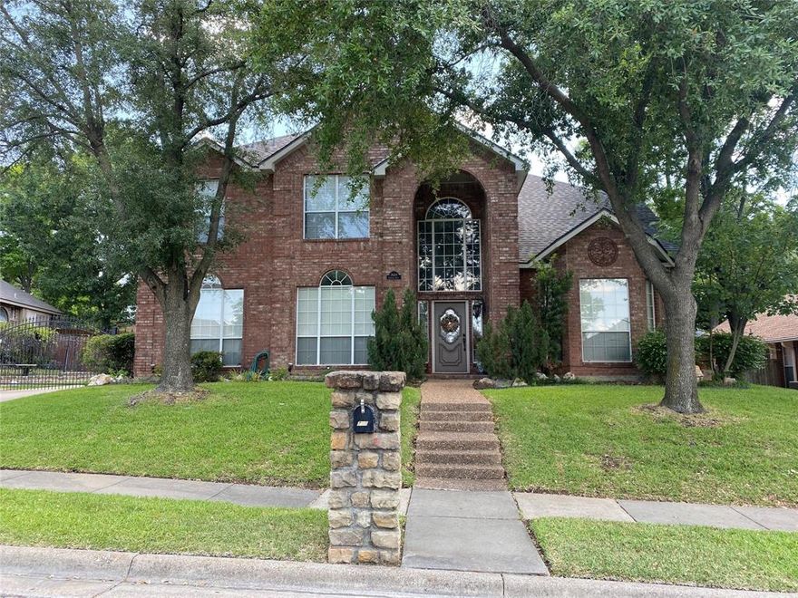 HUGE PRICE IMPROVEMENT! Welcome to this stunning home, thoughtfully designed for a growing or multi-generational family and perfect for entertaining! Step inside to a grand entry with soaring ceilings, gorgeous hardwood floors, and a magnificent wood staircase with an elegant iron banister. The open-concept formal living and dining areas offer versatility and could easily be transformed into a home office. Natural light floods the home through an abundance of windows, creating a bright and inviting atmosphere. A chef’s dream, the expansive kitchen boasts stainless steel appliances, a double oven, granite countertops, a large island, an extended breakfast bar, and ample cabinet storage. Overlooking the breakfast nook and family room, this open layout makes hosting a breeze. Cozy up by the charming brick fireplace on cool evenings in the spacious family room. The luxurious Owner’s Retreat features a serene sitting area and an indulgent en-suite bath with a soaking tub, dual granite vanities, built-in cabinets and shelving, a walk-in shower with dual shower heads and bench, plus two generous walk-in closets. Upstairs, you’ll find three oversized bedrooms, a third living area, and a huge game room, currently being used as a fifth bedroom, offering endless possibilities for relaxation or recreation. Step outside to your private backyard oasis, complete with a tranquil pool, shaded lounging areas, and ample space for outdoor gatherings. A gated driveway adds for privacy and has additional parking plus a three-car garage. Recent Updates: Two AC units replaced in 2023, water heater replaced in 2024, fence replaced in 2025, energy-saving pool equipment installed in 2024. Located in a prime area near parks, walking and biking trails, shopping, dining, and entertainment, with easy access to DFW Airport, Fort Worth or Dallas. With a little TLC, this incredible home can be your forever dream home! Priced to sell as is & still have room for paint, etc. NO HOA!