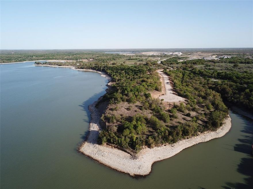 The lake is calling.  Hanna Oak Estates is one of the newest and nicest residential lake communities near the Dallas - Fort Worth area.   The 12,000-acre Lake Bridgeport is a sportsman's paradise for fishing and all types of water sports.  Hanna Oak Estates is conveniently located on the East side of Lake Bridgeport and less than 2 miles from the public boat ramp at Wise County Park.  Hanna Oak Estates provides a newly constructed county-maintained road, underground utilities, beautiful mature trees, and is serviced by West Wise Water.  Sensible deed restrictions in place to protect your long-term investment.   The 1.04-acre lot 12 has 241’ of shoreline along the point and is suitable for a boat dock.