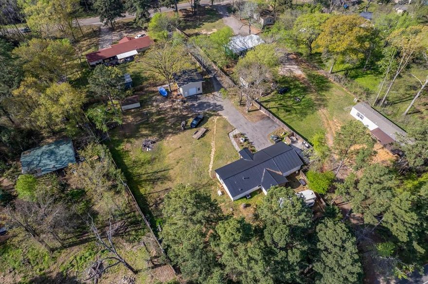 Charming Country Retreat with Modern Updates on One Acre! This beautifully updated 2 bedroom, 2 bath home sits on a spacious one acre lot with access to both Highway 31 and FM 3204, offering peaceful seclusion without sacrificing convenience. Step inside to find a stunning open-concept living area featuring rustic wooden beams, stunning fixtures, and a fireplace that adds warmth and character to the space. The kitchen is a showstopper with modern finishes, ample counter space, a kitchen island, and a seamless flow into the living area. The oversized master retreat is your own private sanctuary, offering plenty of space to relax and unwind, complete with a beautifully updated ensuite bath and a spacious walk-in closet. This home has been thoughtfully upgraded throughout and includes a whole-home generator for peace of mind during any season. Outside, you'll the love the open deck overlooking the spacious yard - ideal for morning coffee or sunset views. Additional features include a 2-car garage, a 15x20 workshop for your hobbies and storage, and a setting that brings the best of country living within reach of town. This property would ideally serve as a primary residence, a weekend retreat, or a short-term rental, and would be an asset to any investment portfolio. Conveniently located between Tyler, and Athens, this property is approximately 10 minutes from Lake Palestine, the Neches River, and local parks.