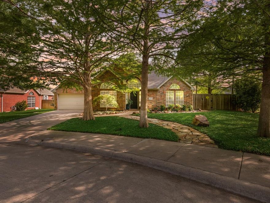Welcome to your own beautiful oasis in the heart of McKinney, offered at an incredible price. A thoughtfully designed kitchen features 42” cabinets, island storage, KitchenAid stainless built-in appliances, a Bosch 3-rack dishwasher, double ovens, and a 5-burner gas cooktop.While the interior offers comfort, flexibility, and smart functionality, the true showstopper is the backyard. Situated on a corner lot and framed by large mature trees, this oversized garden-style yard feels private, peaceful, and full of character. Stone walkways lead through established perennial beds filled with roses, hostas, hydrangeas, hibiscus, wisteria, salvia, and more, creating a rare outdoor retreat for garden lovers, entertainers, or anyone who wants beauty without a traditional grass yard. The flexible 2-bedroom layout lives larger than expected, with a spacious 24’ x 13’ front bedroom that can serve as a home office, guest room, art studio, quilting room, or hobby space. The extra-wide side yard adds even more potential for a storage shed or private outdoor escape. This is a special opportunity for buyers seeking a more manageable floor plan while still enjoying generous room sizes and looking for something truly unique in the heart of McKinney.