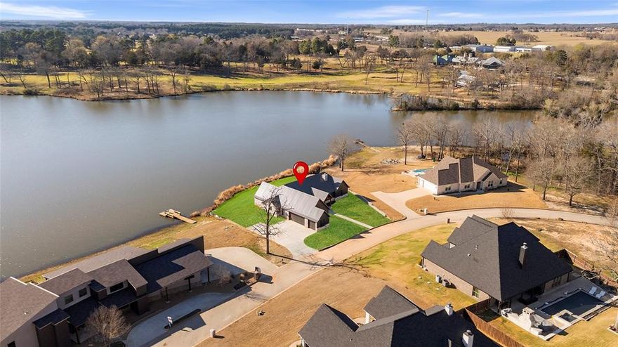 New 2025 construction waterfront home located in the desirable gated Garden Valley community. This thoughtfully designed property offers 3 bedrooms and 3 full bathrooms with an open-concept layout ideal for everyday living and entertaining. The spacious living room features a gas fireplace and flows seamlessly into the kitchen and dining areas. The kitchen includes a center island and granite countertops, complemented by luxury vinyl wood look flooring throughout the main living spaces.
The primary suite offers a private retreat with a walk-in closet, dual vanities, and convenient access to the laundry room. Enjoy outdoor living with a covered patio, outdoor kitchen with built-in grill, and fire pit, all overlooking the water and providing a peaceful setting. Additional features include a two-car garage plus golf cart garage, quality craftsmanship, and modern finishes throughout. Located in a quiet, established community with scenic surroundings.