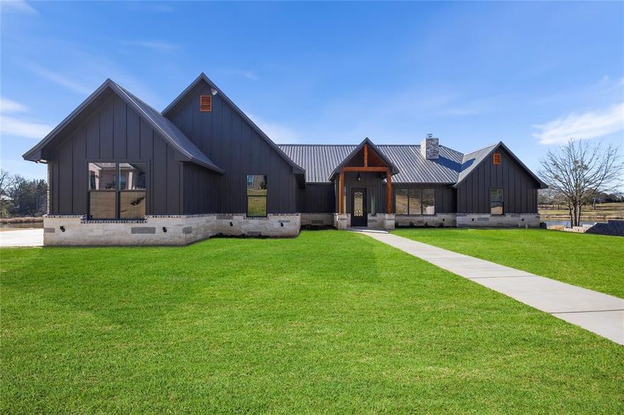 New 2025 construction waterfront home located in the desirable gated Garden Valley community. This thoughtfully designed property offers 3 bedrooms and 3 full bathrooms with an open-concept layout ideal for everyday living and entertaining. The spacious living room features a gas fireplace and flows seamlessly into the kitchen and dining areas. The kitchen includes a center island and granite countertops, complemented by luxury vinyl wood look flooring throughout the main living spaces.
The primary suite offers a private retreat with a walk-in closet, dual vanities, and convenient access to the laundry room. Enjoy outdoor living with a covered patio, outdoor kitchen with built-in grill, and fire pit, all overlooking the water and providing a peaceful setting. Additional features include a two-car garage plus golf cart garage, quality craftsmanship, and modern finishes throughout. Located in a quiet, established community with scenic surroundings.