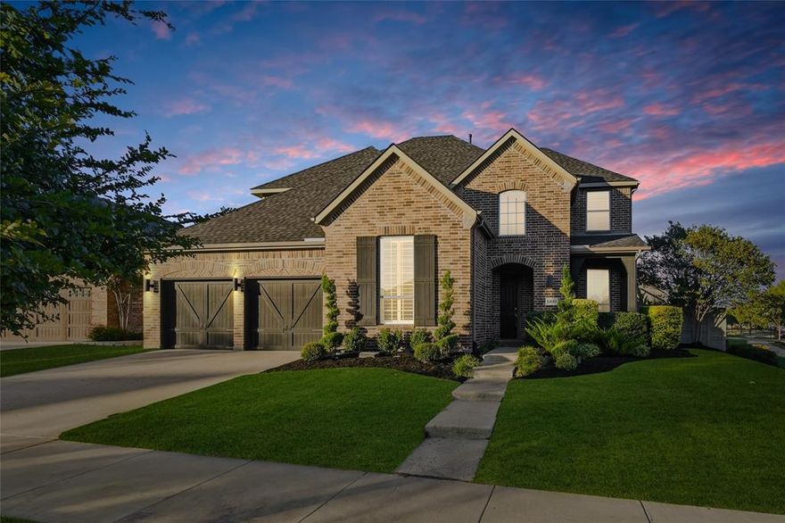 Located in the desirable Harvest community in Argyle, this impressive corner-lot home sits on a premium oversized lot and features a custom pool with dual water features, a diving pedestal, and a fully equipped outdoor kitchen designed for entertaining. The backyard includes upgraded landscaping for added privacy and a new roof for peace of mind. Inside, the home showcases over $80,000 in builder upgrades and additional custom improvements. The open-concept layout includes a media room with wet bar and powder bath, concealed theater wiring with Dolby Atmos surround sound, and built-in speakers in the family room and covered patio. The kitchen features upgraded cabinetry, granite countertops, herringbone backsplash, stainless steel sink, pot filler, and a butler’s pantry with coordinating finishes. Additional highlights include brackish-stained hardwood floors, wrought iron balusters, a raised-hearth fireplace with leuders stone and cedar mantle, and a mudroom with built-in bench. The three-car tandem garage features a professional epoxy and polyaspartic floor coating. The primary suite offers painted cabinetry, upgraded granite, a soaking tub, and elegant tilework. Throughout the home, you’ll find plantation shutters, upgraded lighting, ceiling fans, hidden TV wiring, neutral paint, and eight 4K CCTV cameras surrounding the home. Smart home technology controls the thermostats, lighting, pool, cameras, doorbell, and locks through convenient apps, and a fully paid security system monitors every window and door. The Harvest community offers multiple pools, a fitness center, coffee shop, parks, and walking trails, with convenient access to major highways, shopping, and dining, and is zoned for Argyle ISD.