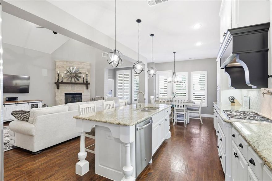 Located in the desirable Harvest community in Argyle, this impressive corner-lot home sits on a premium oversized lot and features a custom pool with dual water features, a diving pedestal, and a fully equipped outdoor kitchen designed for entertaining. The backyard includes upgraded landscaping for added privacy and a new roof for peace of mind. Inside, the home showcases over $80,000 in builder upgrades and additional custom improvements. The open-concept layout includes a media room with wet bar and powder bath, concealed theater wiring with Dolby Atmos surround sound, and built-in speakers in the family room and covered patio. The kitchen features upgraded cabinetry, granite countertops, herringbone backsplash, stainless steel sink, pot filler, and a butler’s pantry with coordinating finishes. Additional highlights include brackish-stained hardwood floors, wrought iron balusters, a raised-hearth fireplace with leuders stone and cedar mantle, and a mudroom with built-in bench. The three-car tandem garage features a professional epoxy and polyaspartic floor coating. The primary suite offers painted cabinetry, upgraded granite, a soaking tub, and elegant tilework. Throughout the home, you’ll find plantation shutters, upgraded lighting, ceiling fans, hidden TV wiring, neutral paint, and eight 4K CCTV cameras surrounding the home. Smart home technology controls the thermostats, lighting, pool, cameras, doorbell, and locks through convenient apps, and a fully paid security system monitors every window and door. The Harvest community offers multiple pools, a fitness center, coffee shop, parks, and walking trails, with convenient access to major highways, shopping, and dining, and is zoned for Argyle ISD.