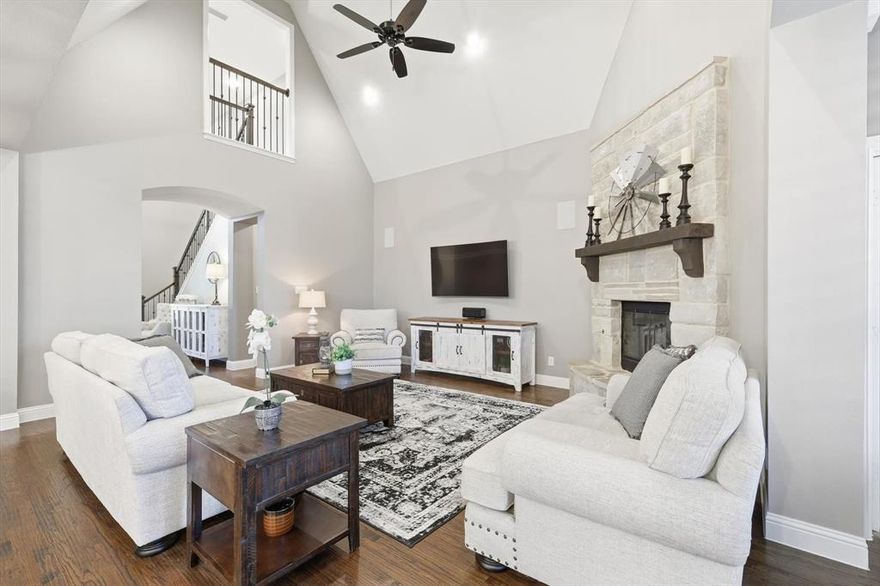 Located in the desirable Harvest community in Argyle, this impressive corner-lot home sits on a premium oversized lot and features a custom pool with dual water features, a diving pedestal, and a fully equipped outdoor kitchen designed for entertaining. The backyard includes upgraded landscaping for added privacy and a new roof for peace of mind. Inside, the home showcases over $80,000 in builder upgrades and additional custom improvements. The open-concept layout includes a media room with wet bar and powder bath, concealed theater wiring with Dolby Atmos surround sound, and built-in speakers in the family room and covered patio. The kitchen features upgraded cabinetry, granite countertops, herringbone backsplash, stainless steel sink, pot filler, and a butler’s pantry with coordinating finishes. Additional highlights include brackish-stained hardwood floors, wrought iron balusters, a raised-hearth fireplace with leuders stone and cedar mantle, and a mudroom with built-in bench. The three-car tandem garage features a professional epoxy and polyaspartic floor coating. The primary suite offers painted cabinetry, upgraded granite, a soaking tub, and elegant tilework. Throughout the home, you’ll find plantation shutters, upgraded lighting, ceiling fans, hidden TV wiring, neutral paint, and eight 4K CCTV cameras surrounding the home. Smart home technology controls the thermostats, lighting, pool, cameras, doorbell, and locks through convenient apps, and a fully paid security system monitors every window and door. The Harvest community offers multiple pools, a fitness center, coffee shop, parks, and walking trails, with convenient access to major highways, shopping, and dining, and is zoned for Argyle ISD.