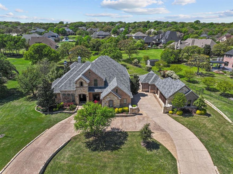 Nestled in the prestigious Clariden Ranch community, this breathtaking estate is an unrivaled blend of luxury and comfort. This magnificent 5-bedroom, 4 ½ bathroom residence includes a large backyard patio and pool on a sunny full acre, a rare oversized additional garage (capable of boat:RV:ATV storage or 6 cars total, and a private in-law suite complete with its own full bath—perfect for guests or multi-generational living. Please see media for floorplan and measurement of rooms.
The property is perfectly situated in north Southlake, close to DFW airport & Southlake Town Square, and within walking distance to the 700 acre Bob Jones Nature Preserve & Sports Complex.  Families can choose between Carroll ISD, Northwest ISD, or the nearby Clariden School.
Step inside to discover an open-concept floor plan that flows from one inviting space to the next, with a gourmet kitchen that will delight any culinary enthusiast, featuring double ovens, a top-of-the-line gas range, and abundant space and light ideal for gatherings.  The primary bedroom suite offers a private sitting area, fireplace, large shower and spa bath, and two large closet areas.  There are two executive study options downstairs, set apart and great for working from home.  Upstairs features 3 large bedrooms with a game room and 2 bathrooms.
Outside, one of this exceptional property’s highlights is the backyard oasis, which will provide an opportunity to host friendly gatherings or relax in tranquility under the sun or stars.  The pool and spa are recently resurfaced, and the spacious entertaining area boasts a fireplace and built-in grilling station with plenty of room for comfort.
This Clariden Ranch gem is the perfect combination of lifestyle, space, sophistication, and serenity.  Don’t miss the opportunity to make this dream retreat your forever home!