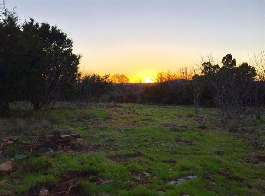 SELLER FINANCING AVAILABLE. LOT CAN BE SPLIT BACK INTO TWO!! Discover the perfect blend of natural beauty and exceptional amenities with this stunning corner lot, ideally situated near the marina. This property offers breathtaking views due to its elevated position on a gentle slope, leading down to a charming, seasonal creek bordered by stepped limestone. The unique topography ensures not only privacy but also picturesque sunsets that transform each evening into a serene escape.
Residents will enjoy a wealth of recreational facilities including access to the neighborhood marina, perfect for boating enthusiasts, as well as tennis courts, a sparkling pool, and a clubhouse. Whether you’re looking to build your dream home or seeking a investment opportunity, this lot offers a lifestyle filled with leisure and luxury.
Adding to its appeal, the seller is open to considering owner financing. Embrace the chance to create your own paradise in this exquisite location.