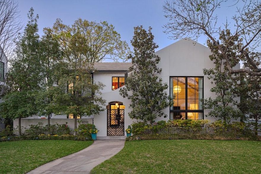 Nestled in one of Dallas’s most coveted enclaves, this custom residence is a masterclass in Mediterranean-inspired coastal elegance. Beyond the discreet, gated entry lies a dramatic private courtyard, an outdoor sanctuary anchored by a statement wood burning fireplace, setting a tone of serene sophistication.

The interiors transition seamlessly into grand scale living and dining spaces, perfectly complemented by a serving bar designed for the modern entertainer. The culinary heart of the home is a gourmet chef’s kitchen, anchored by a signature Bertazzoni range and artisan finishes. The primary wing is a private retreat of its own, located on the main level, it offers floor to ceiling vistas of the lush courtyard gardens and the tranquil rhythms of a private spa water feature.

The second level is equally refined, hosting three generous guest suites, a sophisticated media den, and a secondary laundry suite for ultimate convenience. Positioned just moments from the premier boutiques and celebrated dining of Lovers Lane, this home offers a rare lock and leave luxury lifestyle without compromising on scale or soul.