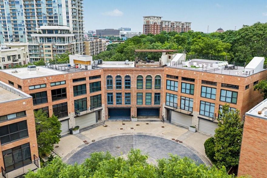 Set directly on the Katy Trail, 2927 Magnolia Hill Court doesn’t rely on the familiar cues of a townhome. Here, you’ll find the warmth of a loft that’s been sharpened by industrial details — black steel, exposed wood & expansive windows. The second floor serves as the home’s social hub. Living, dining, and kitchen spaces run the full width of the floor, with floor-to-ceiling glass on the trail-facing side that keeps the tree canopy and future Loop Plaza in constant view. A suspended fireplace anchors the upper sitting area, while an enclosed patio extends the entertaining footprint with built-in BBQ, wine storage, and covered seating. At the center of the open plan, the kitchen is both polished and practical. Dark cabinetry, professional-grade appliances, and a generous connection to the surrounding living spaces allow cooking and conversation to unfold naturally in the same room. On the level below, a bedroom suite nearly 30 feet deep opens directly onto a private outdoor deck. Fully enclosed with vertical wood slat fencing and mature hedging, the space functions as an outdoor room — a genuine rarity at this address. The third floor holds the primary suite alongside a study that converts comfortably to a fourth bedroom. In the primary bath, double vessel sinks, a glass-enclosed shower, and a slatted wood ceiling detail carry the home’s material continuity into its most private space. A walk-in closet and dedicated utility room complete the level. A two-car garage and access to the community pool add ease to the everyday. 2927 Magnolia Hill Court sits steps from the Katy Trail, with American Airlines Center, Uptown, and the Design District all within easy reach.