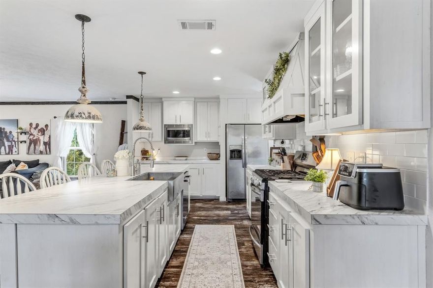 Charming 2020 manufactured farmhouse-style home on nearly an acre, complete with a 20x25 shop and a cozy outdoor fire pit area—perfect for enjoying quiet country evenings. This open-concept 4-bedroom, 3-bath home features a split-bedroom layout and is loaded with modern finishes and amenities throughout.

The kitchen is truly the heart of the home—huge in size and designed to impress—with an abundance of cabinet and countertop space, decorative lighting, a large island, and a classic farmhouse sink, making it ideal for entertaining or everyday living.

The spacious primary suite offers a private retreat with an ensuite bath featuring a double vanity, soaking tub, tile shower, and walk-in closet. A secondary bedroom is generously sized and could easily serve as a second master, complete with access to a shared ensuite bath.

Conveniently located just minutes from town while still offering the peace and quiet of country living. ??? Fiber internet is available, and the home is set on durable concrete runners.

Come on home—this one truly is a beautiful place!!