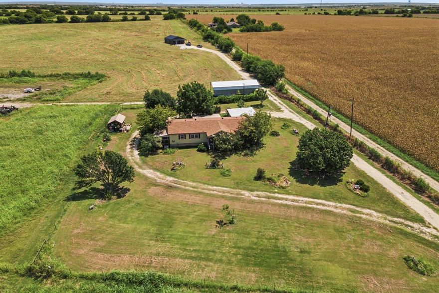 Build your dream home where you can actually see the stars at night.  Plenty of room to farm or develop this approximately 49 acres of beautiful country land that's been in the same family for generations.  Large 3-2 mobile home with carport and two sheds, as well as a spacious 2024-built one-bedroom, one-bath barndominium house that sits far enough back on the land for added privacy and would be great as mother-in-law quarters.  Approximately 30 minutes from either Dallas or Ft Worth.  Has Ag exemptions.  Has a small pond. Mountain Peak Water Supply is the water provider.  Electricity is thru United Coop Electric. Three septic systems.  The property is at least partly and maybe wholely in the Venus ETJ.  This involves multiple parcels, and the acreage shown includes all of the parcels.  The sellers will consider selling the parcels separately. 2 acres along the front left corner at the road sold, which is why the total acreage is 48.797.
