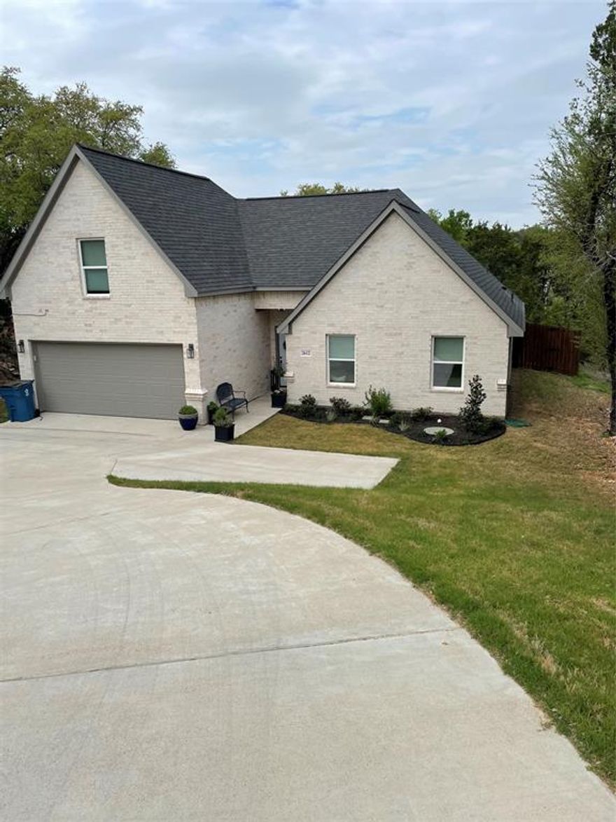 SELLER WILL PAY $5,000 TOWARD BUYER CLOSING COSTS WITH ACCEPTABLE OFFER!! 
Seller added front landscaping! Beautiful home in a gated and guarded community! Gorgeous stylish light-colored brick on all 4 sides. Step into this wonderful home through the front into the beautifully tiled entry with built-in shelves leading into the big living room with lots of natural light from the large windows and a vaulted ceiling giving the look of expanse. As you walk through, take notice all the gorgeous modern custom light fixtures! The master bedroom is on one side of the house and the two guest rooms are on the other side. The master is large enough for a small sitting area in the bedroom and has lots of natural light with two large windows. The luxurious master bath is both stylish and functional with a large shower, double sinks and a large walk-in closet. The other two bedrooms are perfect for kids or guests with a hall bath that has a tub with a shower. The kitchen has lots of cabinet space, a built-in breakfast counter and is equipped with an electric range and dishwasher. Right off the kitchen is a separate laundry room with a huge pantry inside. The adjacent dining area overlooks the exterior deck and trees. Upstairs is a large bedroom room with a walk-in closet that could be a media room, playroom, or office. The back yard is fenced and there is a big wooden deck built on the back of the house. The deck is great for morning coffee listening to the birds, dining anytime or entertaining. There are lights for nighttime entertaining or for a peaceful glass of wine. This is a wonderful house and the included POA has some fabulous features including a gated-guarded entry, a clubhouse, 2 parks, basketball and tennis courts, two swimming pools and a fishing dock. Come buy this fabulous house and take advantage of the wonderful amenities!  You don't have to have a home swimming pool to take care of in this community with two pools for residents.