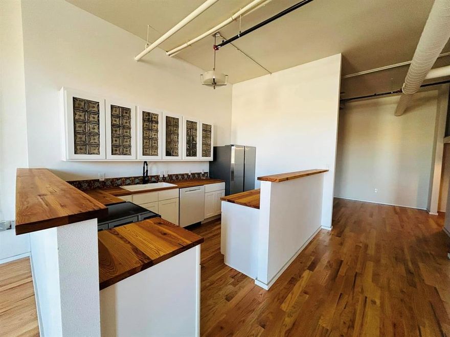 Discover a unique blend of history and modern living in the newly restored Dickson Hardware Building, a cherished Cleburne landmark now reimagined as stylish urban lofts. Located in the heart of downtown at 201-205 E Chambers Street, these thoughtfully designed residences offer a one-of-a-kind living experience with character you won’t find anywhere else.
Unit 205 showcases distinctive artisan touches, including double vanity, hand-painted sinks and custom hand painted tile showers, celebrating craftsmanship and individuality. Reclaimed wood butcher block countertops provide warmth and function, perfectly complementing the building’s exposed ceilings and original architectural features that tell a story of the past. Large windows in the living area bring in a ton of light. 
Modern conveniences meet vintage charm with off-street parking, in-unit amenities, and a walkable downtown location near shops, dining, and cultural attractions. Be part of Cleburne’s living history. Multiple units available. 
Multiple units available. This building is a walk-up. No elevator.