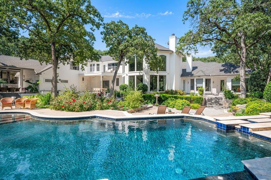 Tucked away in the prestigious Coventry Manor estate, this stunning modern architectural home offers 5 bedrooms, 6 baths, and over 1.1 acres of serene privacy in Carroll ISD. Situated on a spacious corner lot in a quiet cul-de-sac, this residence is surrounded by lush, mature trees, creating a true backyard oasis. Enjoy a sparkling pool and spa with a tranquil waterfall and lighting, perfect for relaxation and entertaining. The home boasts soaring ceilings, abundant natural light, whole-home surround sound, and extensive upgrades, including a brand-new HVAC system (2024) and a roof replacement (2017). Adding to its appeal, a separate 1-bedroom, 1-bath guest house with a full kitchen offers comfort and privacy for visitors or multigenerational living. Designed for both comfort and luxury inside and out, this exceptional property is a rare find in an exclusive setting. Guest house and pool house are included in overall square footage.