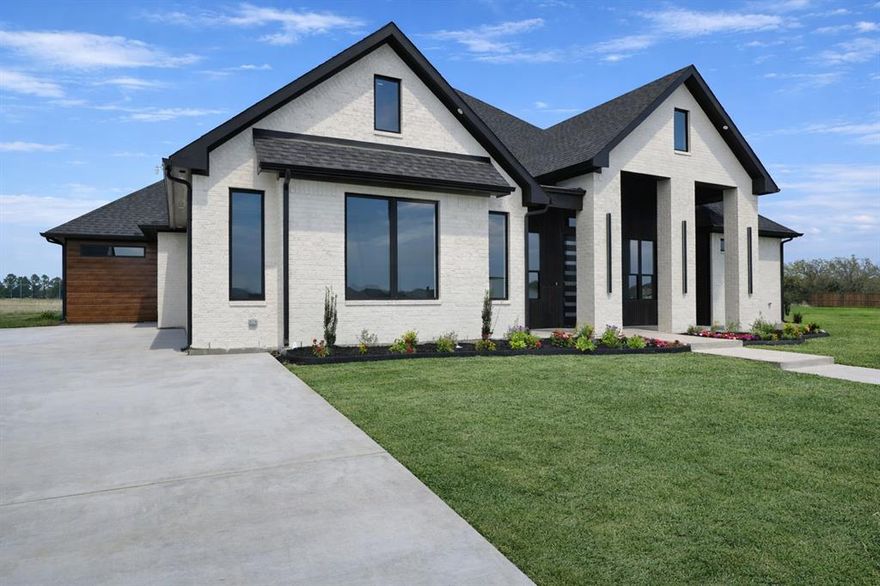 Located in prestigious Fountain Creek Estates, this newly constructed one-story home offers a bright, open layout filled with natural light and thoughtfully selected finishes throughout. Expansive 7-foot windows, 10-foot ceilings with dramatic 14-foot accents, and beautifully trimmed ceilings create a spacious and refined feel from the moment you walk in.

The kitchen and living areas are designed for both everyday living and entertaining, featuring 10-foot custom cabinetry, a gas cooktop, large island, walk-in pantry, built-in dry bar, and a sleek electric fireplace that anchors the main living space. A private office and game room provide flexible areas for work, relaxation, or hosting guests.

The primary suite offers a relaxing retreat with spa-inspired finishes including a separate shower and soaking tub, dual vanities, and a custom primary closet. A spacious utility room connected to the primary closet adds everyday convenience. The home includes 4 bedrooms and 3.5 bathrooms, offering plenty of space for family and visitors.

Beautiful porcelain tile and engineered wood flooring add durability and style throughout the home, while foam spray insulation enhances energy efficiency and year-round comfort.

Step outside to a covered patio and an incredible backyard view overlooking open land for miles, creating a peaceful setting with wide-open Texas skies rarely found in neighborhood living. Combined with a side-entry two-car garage and fresh landscaping, the home delivers strong curb appeal and timeless design.

A standout new construction opportunity in one of Pottsboro’s most desirable communities, just minutes from Lake Texoma, Pottsboro ISD, marinas, dining, and everyday conveniences.