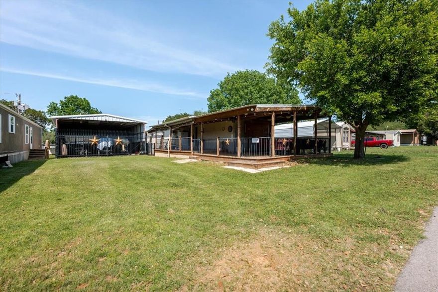 Located in a charming lake community, this home is just a short walk from the community dock, making it perfect for water lovers. The property features a generous carport that currently fits two boats and a golf cart, plus 2 stoage sheds and two improved closets. New French door, all new plumbing, and house leveled. Inside, the home is cooled by a robust commercial-grade AC unit, offering reliable comfort through every season. Washer, dryer and new outside TV and most furniture convey. Riding lawn mover in great condition can convey with full price offer.  Whether you're entertaining guests or enjoying quiet weekends by the water, this home offers both practicality and prime location in a welcoming lakefront neighborhood. Leasehold land. Current lease is $750.00 + water and trash, and will likely be invreased for new owners. Pontoon negotiable.