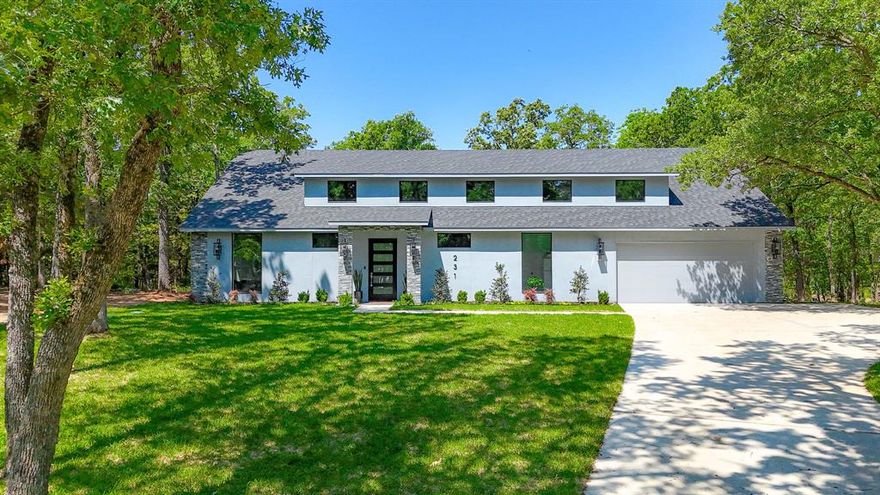 This stunning newly built home with rear lake access is situated in the highly sought after Wilderness Subdivision, offering peaceful water access right in the backyard. Surrounded by towering trees and abundant wildlife, including freely roaming deer, it offers a peaceful retreat from the everyday. The home offers a modern design, quality craftsmanship, and luxurious finishes throughout. Featuring an open concept layout, the spacious living and dining areas are filled with natural light, highlighted by soaring 18-foot ceilings. The gourmet kitchen is equipped with sleek granite countertops, custom modern cabinetry, stainless steel appliances, and a large island. There is also a butler’s pantry and a dry bar which is perfect for entertaining or everyday use. The primary suite is a true haven, featuring a spa like ensuite with a soaking tub, separate shower, double vanity, and two large walk-in closets. Two additional spacious bedrooms provide comfort for family or guests, while a versatile bonus room adapts to your needs, could be used as a 4th bedroom, media room, or game room. One bedroom even serves as a second primary with its own ensuite. Upstairs, a private guest suite that has space for a kitchenette, laundry, full bath, and walk-in closet. Step outside to enjoy the screened in patio and covered back porch, where you can take in the peaceful surroundings. The backyard features a fire pit, ideal for unwinding under the stars. With water access just steps away, this home is perfect for lake lovers seeking both relaxation and adventure. Don’t miss the opportunity to make this lake house your own!