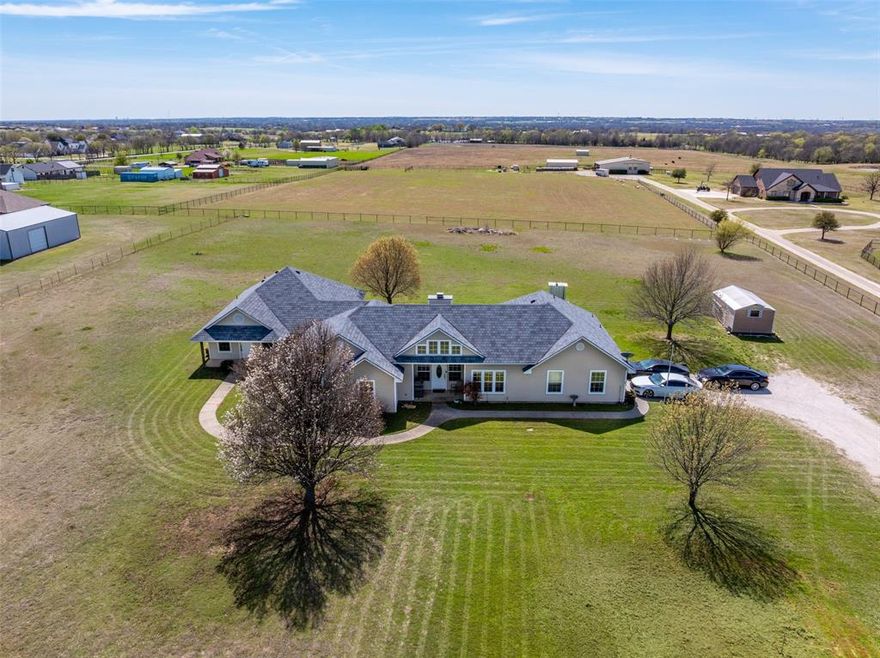 Set on 3 beautiful acres just outside Sanger, this exceptional multi-generational estate offers a rare blend of space, flexibility, and refined country living. Designed as two homes under one roof, the property is ideally suited for extended family living, private guest quarters, or a true mother-in-law suite. The main residence features 4 bedrooms and 2 baths, a light-filled living area with vaulted ceilings and architectural display space, and a striking wood-burning rock fireplace as its focal point. The kitchen offers a counter bar, adjacent breakfast area and large pantry. It flows seamlessly into the living space. A versatile game or flex room connects effortlessly to the private second living quarters. The separate living space includes 2 bedrooms and 1 bath with a garden tub and full accessible shower, along with a stackable washer and dryer. A private front entrance welcomes you into the living and dining areas, while the full kitchen opens to a covered back patio—creating a comfortable and independent retreat. Designed with accessibility in mind, the addition meets ADA requirements, including accessible bath, bedroom, doors, hallway, and customized wheelchair access. Both living areas offer direct patio access, allowing for a lifestyle that can be shared or completely independent. With 3 usable acres ready for your vision—bring your horses and build a stable, expand the existing workshop, add an in-ground pool, or plan future expansion—this is a rare opportunity to create a lasting legacy property in one of North Texas’ most desirable and growing areas. Unwind as you follow the gently rolling, curved roads into this peaceful setting. Enjoy the best of country living while remaining within close proximity to modern conveniences—shopping, dining, and easy commutes. Surrounded by neighbors who embrace the lifestyle, with horses, cattle, and even a private landing strip nearby, this property invites you to imagine what’s possible. What’s your dream?