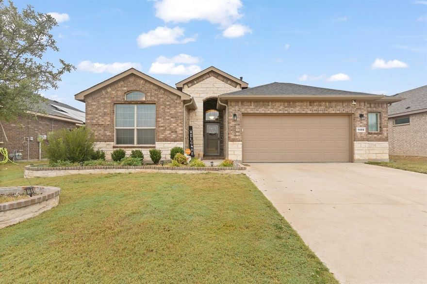 Welcome to this stunning 4 bedroom, 2 bath home offering over 2,100 square feet of comfortable living space. From the moment you arrive, you'll love the charming curb appeal with its brick and stone exterior and well kept landscaping. Step inside to an open-concept layout perfect for entertaining and everyday living. The spacious living room flows into the kitchen and dining area. Featuring a large island with breakfast bar seating. The cozy dining nook offers plenty of natural light and views of the backyard. The primary suite provides a relaxing space with large windows, dual sinks, walk in shower and a generous closet. The 3 additional bedrooms offer plenty of space for family, guests or a home office. Enjoy outdoor living on the covered patio overlooking a spacious fenced backyard perfect for gatherings, pets, and play. Located in a friendly neighborhood close to schools, shopping, and dining. This home offers both comfort and convenience.