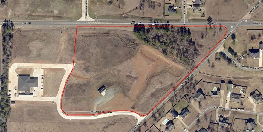 Commercial Development Opportunity!  Approximately 15 acres (more or less), of mostly cleared prime development land.  Property is anchored by the new Minden Medical Clinic of Haughton, sits just across from Haughton Middle School, and is surrounded by newer upscale residential developments.   The property has over 3,300 feet of road frontage on 3 different streets including a state highway.  There is also two existing high visibility corners, at Hwy 3227 and N. Hazel, and another at N. Hazel and Healthcare Plaza Dr.  Community water, sewer and high speed internet are also available.  This is a prime location for both office and retail development in one of the fastest growing areas in the State.