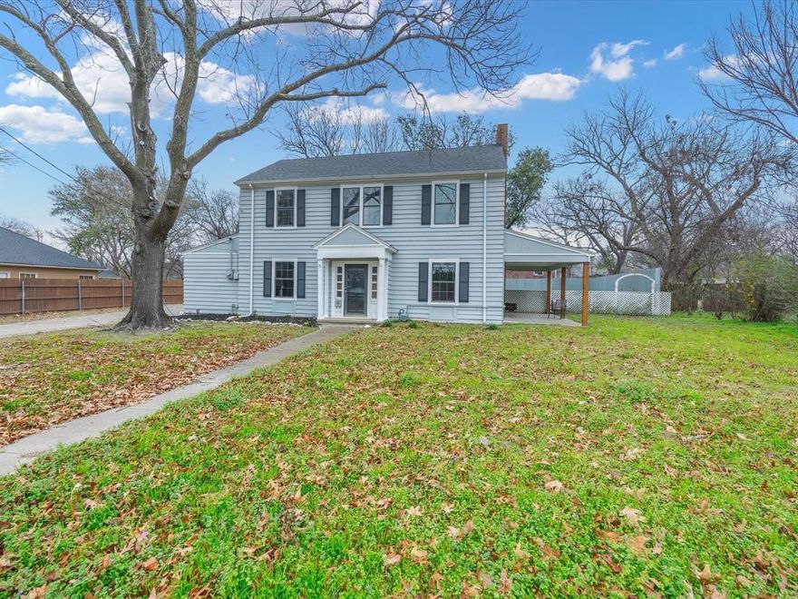 Discover the timeless charm of this beautiful 1930 home, originally given as a wedding gift from a well known local railroad executive to his daughter. Located in Ennis’s historic district, this three bedroom, two bath home sits on an oversized lot with a large backyard, mature shade trees, and a detached oversized two car carport. Inside, a welcoming grand entry with a wide staircase sets the tone, leading to a living room featuring a striking marble gas fireplace and French doors that open to a side patio. The dining room offers an inviting space for gatherings and special occasions. Upstairs, two spacious bedrooms showcase hardwood floors along with classic beadboard walls and ceilings. Notable updates include a new roof, updated kitchen and bathrooms, and a den, bedroom, and bath addition completed in the 1960s. With its blend of historic character, thoughtful updates, and an excellent location, this home is a rare find in Ennis. Schedule your private showing today.