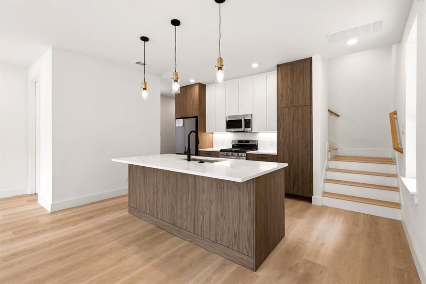 Modern new construction just minutes from Bishop Arts. This 3-bedroom, 2.5-bath home offers three levels of thoughtfully designed living with stunning Dallas skyline views from the upper level. Bright, open-concept interiors feature wide-plank wood flooring, oversized windows, designer lighting, and sleek modern finishes throughout. The spacious kitchen flows seamlessly into the main living and dining areas, creating the perfect setup for entertaining or everyday living. Private bedrooms each offer en-suite baths, while the primary suite features a spa-inspired bath and generous walk-in closet. Enjoy the convenience of a low-maintenance lifestyle paired with unbeatable access to Bishop Arts dining, shopping, nightlife, and Downtown Dallas. A rare opportunity to own stylish city living with elevated views.