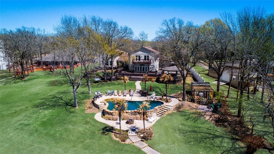 Lakeside Paradise on Richland Chambers!!! Perfect for your large family and gatherings. Enjoy beautiful views of the sunset every evening, modern rock POOL with beach entry, large 2 level boat house with all new wood and stain, 2 jet ski lifts and 1 boat slip. The expansive multi-level outdoor deck and gazebo with hot tub. The House boasts THREE huge Primary suites with private bathrooms plus 2 oversized bedrooms. The house incorporates lots of fun amenities with a spacious game room, theater, exercise room. The beautiful gourmet kitchen is perfect with lots of space to cook and entertain; granite island with seating; Subzero, Dacor, Wolf appliances. No HOA on a Private - QUIET- Secluded Road. *Multi-Generational Living* 

Turnkey (furniture Negotiable) Ready to move in!