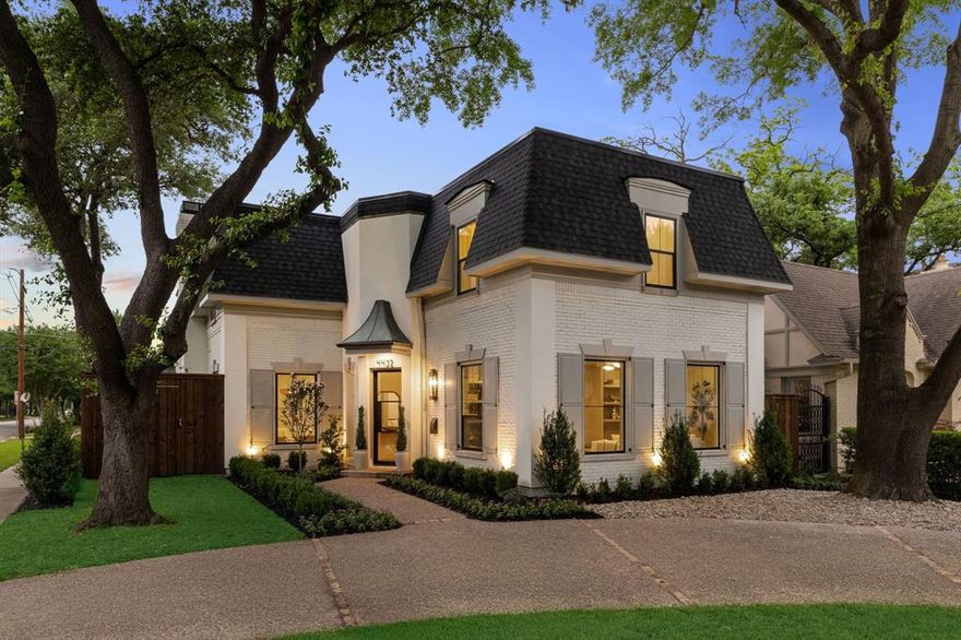 This distinguished French Provincial residence is a rare expression of elevated design where every surface, material, and architectural detail has been meticulously curated to an uncompromising standard of luxury, refinement, and craftsmanship. Located in highly acclaimed HPISD and zoned to Bradfield Elementary this property boasts white oak hardwood floors, custom millwork, imported reclaimed hand-hewn beams, and Moroccan unlacquered brass fixtures creating a warm architectural statement, elevated by steel-and-glass doors and expansive new windows that fill the home w natural light. The kitchen is a refined centerpiece anchored by a Taj Mahal quartzite waterfall island, equipped w integrated Sub-Zero refrigeration, a Wolf 48-inch gas range, double ovens and custom white oak cabinetry designed for elevated entertaining. Designer lighting by Visual Comfort, Amber Lewis and Ralph Lauren adds sophistication throughout while Venetian plaster fireplaces serve as sculptural focal points, including a living room fireplace adorned w Calacatta Vagli Gold and Moca Crema travertine. The primary suite is a 5-star retreat w private balcony and fireplace, double vanities, a dramatic wet room w soaking tub, dual rainfall showers and custom closets. Secondary baths showcase rare stone, artisan zellige tile, and curated finishes while the statement powder bath features custom wallpaper, Blue Roma Quartzite and Moroccan marble. The home also offers a formal dining room, private study, second living area and dual utility rooms. System upgrades include a new commercial-grade TPO roof, Lennox and Ruud HVAC systems and two tankless water heaters. Outdoors, impressive steel and glass accordian doors usher you to a resort-style setting complete w renovated pool and heated spa clad in zellige tile w fresh coping and plaster, lush landscaping, turf, sod, and privacy fencing w stucco columns. A rare blend of elevated materials and timeless design in one of Dallas’s most prestigious enclaves.