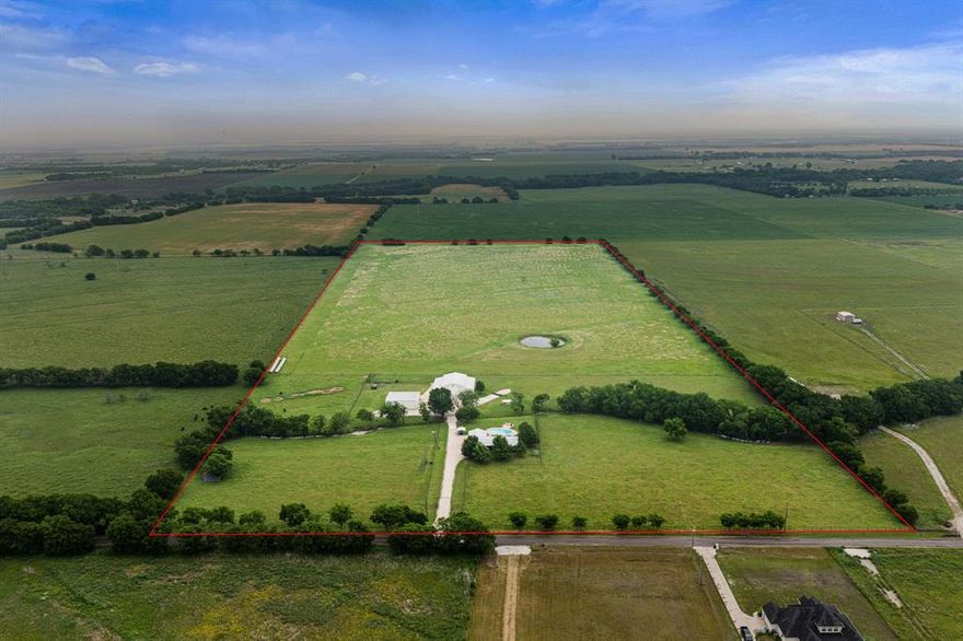Set on 43.2 acres of prime Texas land, this fully equipped ranch offers a rare combination of privacy, functionality, and lifestyle. Enter through the automatic gated entrance and follow the long gravel drive to a beautifully maintained 3 bedroom, 3 bath home with over 1,800 square feet.
Inside, the home is warm and inviting with a stone fireplace, open living spaces, and views of the land in every direction. Out back, the setting truly stands out with a beautiful pool, a custom built deck perfectly positioned to take in the views, and a fire pit area ideal for entertaining or relaxing in the evenings. The land is a strong mix of open pasture ideal for cattle, horses, or hay production, along with a pond and a creek running through the property. Mature, established trees including oaks and hardwoods add character and shade, while seasonal wildflowers like bluebonnets and Indian paintbrush bring the landscape to life. The property is clean, usable, and well laid out for both recreation and operation, and currently holds an agricultural exemption for added value. The improvements take this property to another level. The 30x50 shop is fully equipped with concrete floors, full electric, welder plugs, air compressor setup, shop sink, and a 12,000 lb. lift. The 40x60 barn offers ample space for equipment and storage with a loft for additional capacity, along with horse stalls and plumbing already in place for expansion. Multiple RV hook ups already installed. Water filtration system. You’ll also find multiple barns, covered areas, carports, and multiple gated access points for easy movement throughout the property. A 500-yard shooting lane adds another layer of functionality and recreation, making this property as versatile as it is beautiful. Whether you’re running livestock, operating a business, or simply looking for a private, turnkey ranch, this property delivers. Properties with this level of setup, usability, and condition rarely come to market.