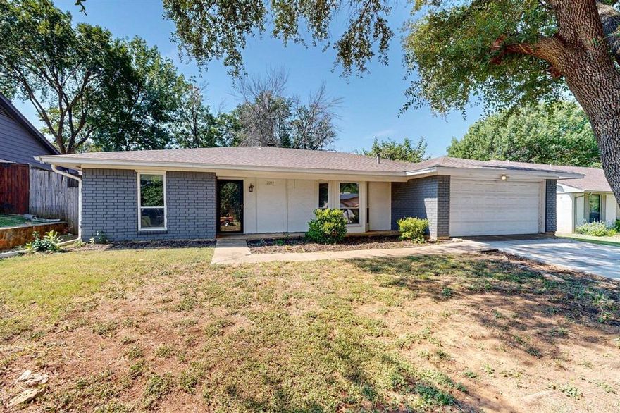 Outstanding opportunity to get into Grapevine-Colleyville for under $400,000! Charming ranch home, just 2.5 miles from Downtown Grapevine and a short drive from Grapevine Lake and a walk to Dove Park, with fresh kitchen updates, paint, recent foundation repairs and ready for new owners! Mature front yard tree and charming drive-up on a quiet street, inside features low-maintenance vinyl flooring, large living room centered with brick fireplace and island to kitchen. Kitchen with new quartz countertops, appliances, and undermount sink. Hall bath with tub. Large master living room. Sizeable backyard with cinderblock retaining wall backing up to property. A fantastic opportunity!