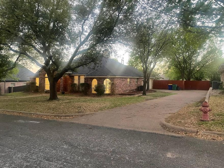 Beautifully remodeled brick home located near the end of a gorgeous street with many mature trees.  This spacious 3bd 2bth home has new paint and flooring in much of the house.  The high ceilings and large windows make it feel extra spacious.  Plus the large kitchen with breakfast nook make the house perfect for entertaining.  The large master bedroom includes a huge master bathroom, including separate shower and bath, his and her vanities, and two large walk in closets.   Two car attached garage, oversized laundry room, spacious backyard, fireplace.  This home is a must see!