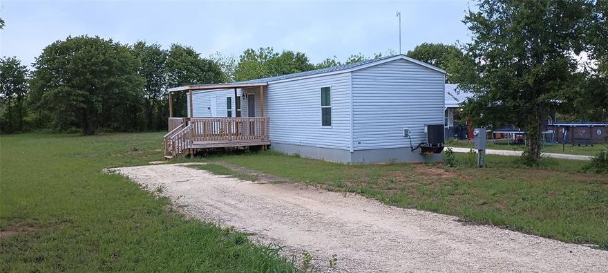 2022 Champion manufactured home 3 bed 2 bath , 2x6 Exterior walls, wind zone 3 home, sits on a 15, 000 sq. ft. lot. Lots of room for a garage. 144 sq.ft. covered front deck, Skirting is 2x4 wall . Home has been attached to property. This lot is removed from HOA.  This home is in it's 2nd location. Was set by State certified installer and brand new standard septic system. no fees.