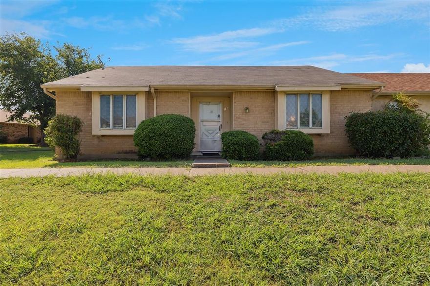 There's a $4000 buyer closing cost concession on this move-in ready and in a desirable end-unit location! Fresh paint and a great versatile floor plan make this home easy to love. Full-size washer-dryer area, breakfast bar, and an open kitchen add to the functionality. Enjoy a small backyard plus covered parking for two, with extra guest parking conveniently located across the alley. Relax in the greenbelt area right out front with its charming covered seating. The community offers a sparkling pool and beautiful green spaces. Affordable HOA covers most exterior maintenance, common areas, sanitation, and water & sewer—no city water bill!   The HVAC system was recently replaced in the last couple of years.  Perfectly located just minutes from I-20 and GB Toll Road (161), with I-30 and 360 close by. These units move quickly—where else can you find a spacious three-bedroom, two-bath with covered parking at this price?