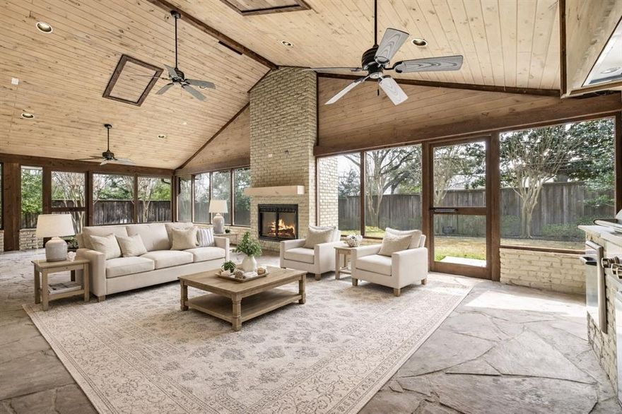 Nestled in the prestigious Preston Hollow Janmar neighborhood, this beautifully updated ranch-style residence sits on an expansive 0.4-acre, tree-filled lot surrounded by rolling hills and mature landscaping—offering rare privacy and a true sense of retreat. Thoughtfully remodeled in 2012, the 2,914-square-foot single-story home blends timeless charm with modern comfort and includes the added peace of mind of a Generac natural gas whole-home generator.

Abundant natural light fills the open-concept living and kitchen areas, creating an inviting space ideal for both everyday living and effortless entertaining. The living area flows seamlessly into a spacious dining room, perfect for hosting gatherings large and small. The kitchen is well-appointed and open to the main living space, keeping the heart of the home connected and functional.
The serene primary suite features a well-designed split bath with dual sinks and separate toilet areas, sharing an expansive glass-enclosed shower—offering both luxury and convenience. Two additional bedrooms and bathrooms provide comfortable accommodations for family and guests.
Step outside to a stunning screened porch complete with a built-in gas grill and fireplace, overlooking the large, tree-shaded backyard—an ideal setting for year-round outdoor living, entertaining, or quiet evenings under the canopy of mature trees.
Adding to the home’s appeal is a unique garage setup with access from both the front and rear of the property, with electric gates located at both entrances—providing enhanced privacy, security, and ease of access. This exceptional property offers the perfect blend of tranquility, functionality, and refined living in one of Dallas’ most sought-after neighborhoods.