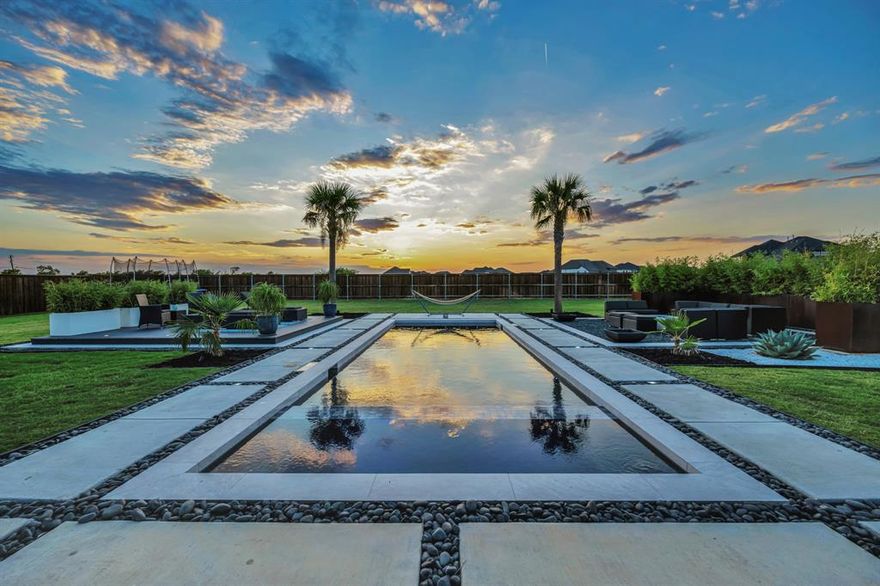 Built by PentaVia custom Homes at The Vines, the premier builder known for unmatched craftsmanship and quality that lasts, this 2023 home captures the essence of laid-back luxury and effortless entertaining.

From the moment you step inside, the warmth and flow of this 3,924 sq ft retreat draw you in. Wide open living spaces and thoughtful design make it just as easy to host a lively gathering as it is to unwind in peace.

At the heart of the home, the chef’s kitchen invites connection with its oversized island, professional 6-burner gas range, and custom cabinetry that opens seamlessly to the living and dining areas. Large sliding glass doors extend your living space outdoors, creating the perfect indoor–outdoor experience for dining, entertaining, or simply enjoying the evening breeze.

Upstairs, two spacious bedrooms each offer private en-suite baths, providing comfort and flexibility for guests or family. The media room with built-in audio-visual systems makes movie nights and weekends feel like an event.

Outside, the resort-style backyard sets the scene for year-round enjoyment with a sparkling pool and spa combo, fire-pit lounge, deck, and extended covered patio—all framed by open skies and wide Texas sunsets. And with no neighbors behind… for-ev-er, your privacy and peace are here to stay.

Set on an .5 acre lot with a three-car side-split garage, this home combines quality, style, and heart in a way that’s hard to find. Built for gathering, relaxing, and celebrating the good life—every single day.